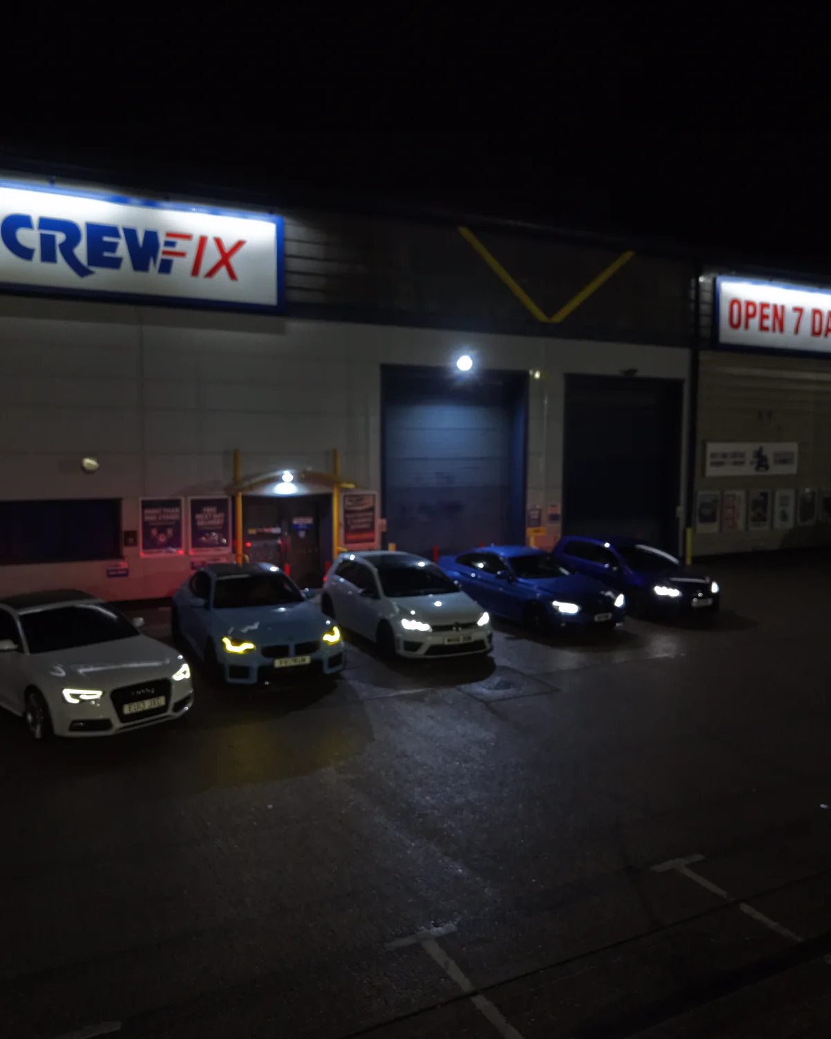 An automotive shoot under workshop lights after dark